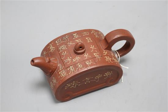 A Chinese Yixing ruyi head shaped teapot, with slip decoration, L. 17.5cm
